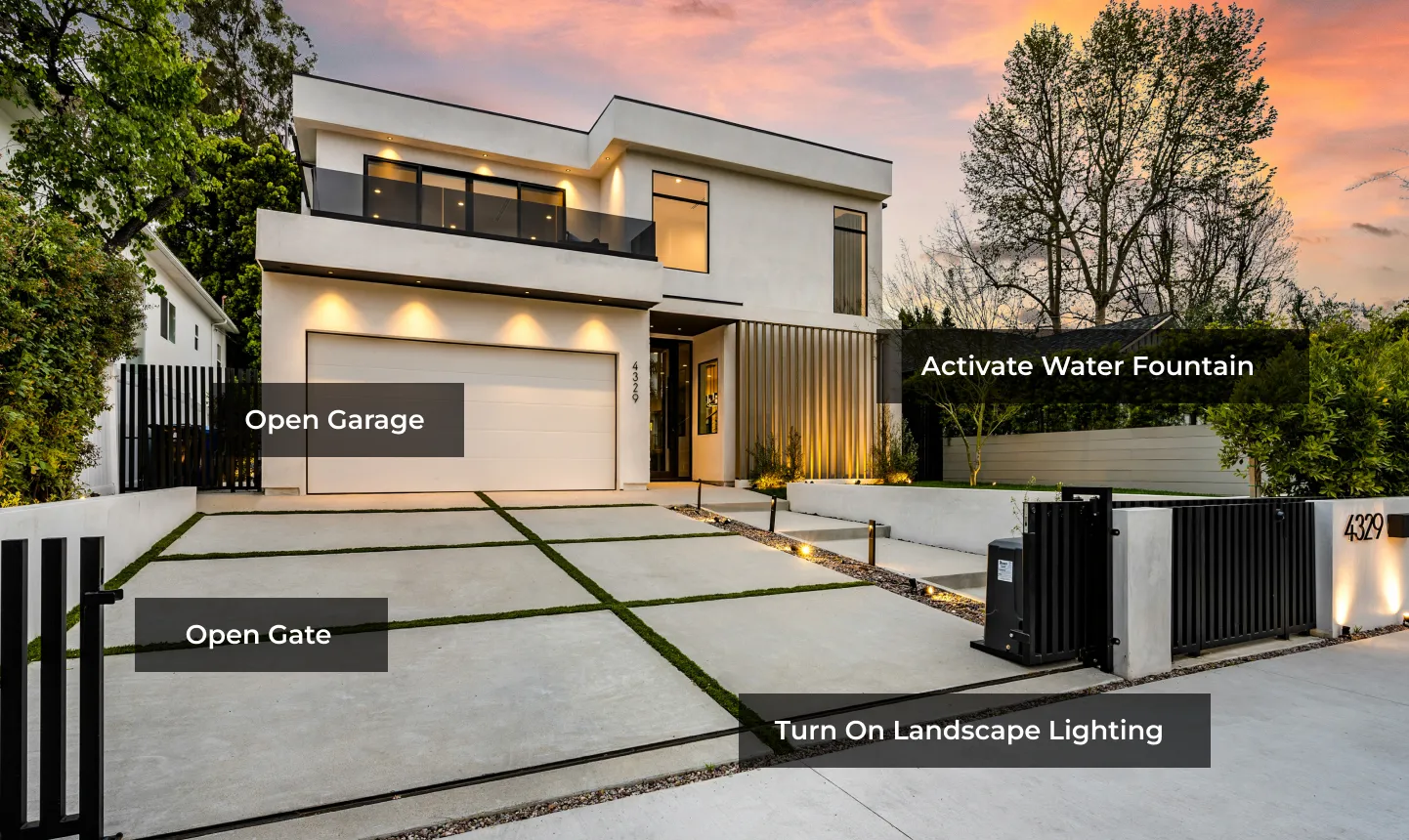 Modern smart home exterior with automated outdoor lighting, gate, and water features