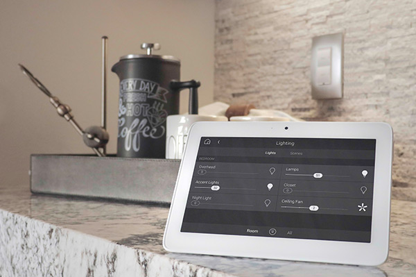 Home automation tablet showing security controls in modern kitchen